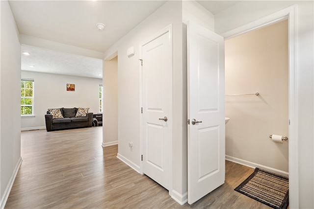 hall with light hardwood / wood-style floors