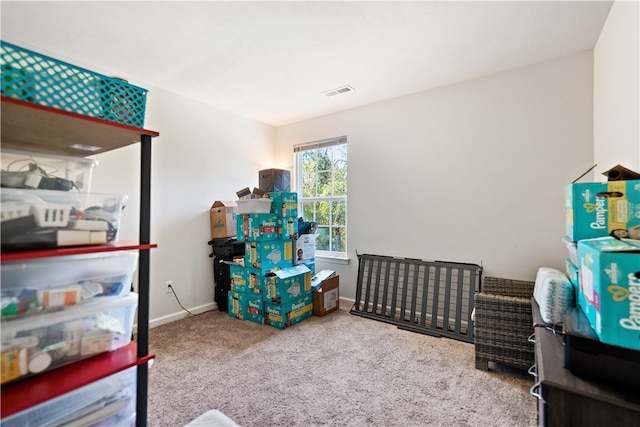 bedroom with a crib and carpet flooring