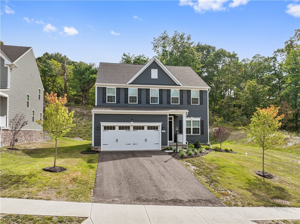 view of front facade featuring a front yard and a garage