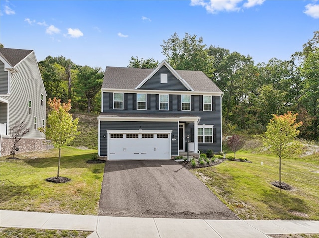 view of front facade featuring a front yard and a garage