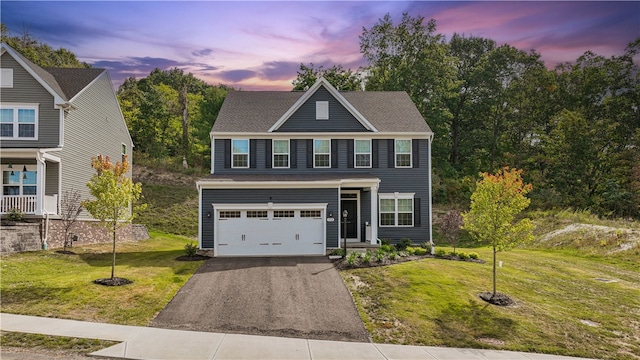 view of front facade featuring a yard and a garage