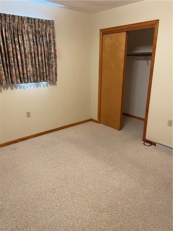 unfurnished bedroom featuring a closet and carpet