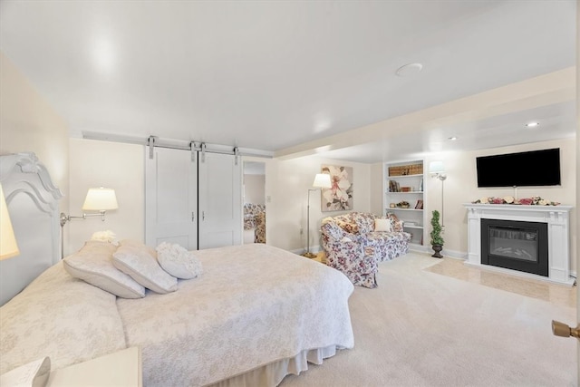 carpeted bedroom featuring a barn door