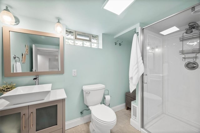 bathroom featuring vanity, tile patterned floors, toilet, and a shower with shower door