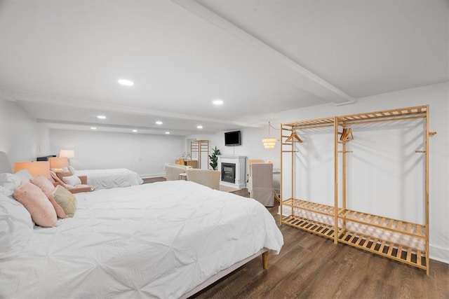 bedroom featuring wood-type flooring and beamed ceiling