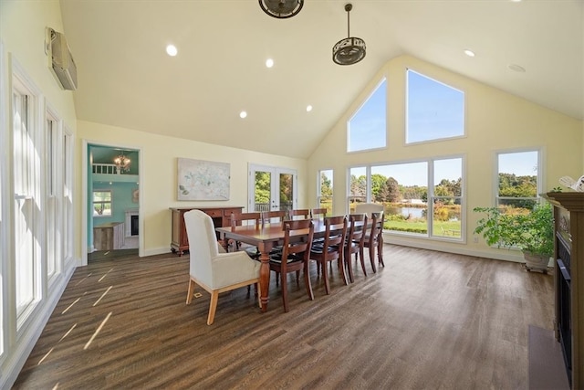 dining space featuring dark wood-type flooring, high vaulted ceiling, and a wall mounted air conditioner