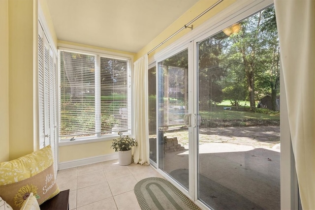 doorway to outside with light tile patterned flooring