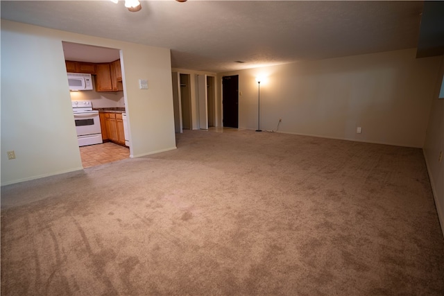 unfurnished living room featuring light colored carpet