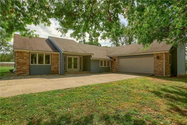 single story home with a garage and a front lawn