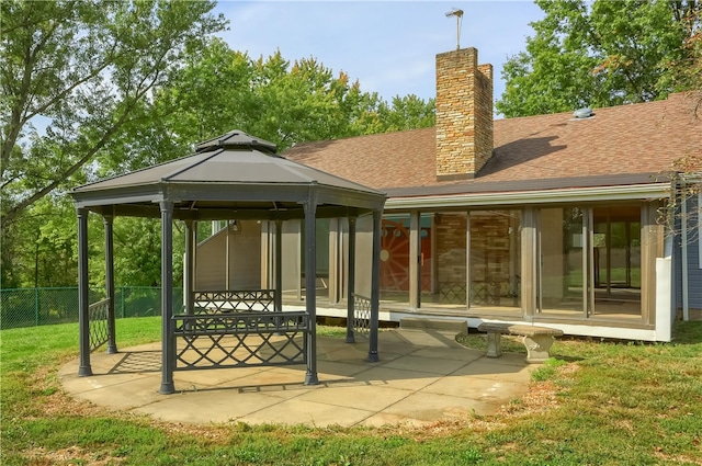 back of house featuring a gazebo, a lawn, and a patio area