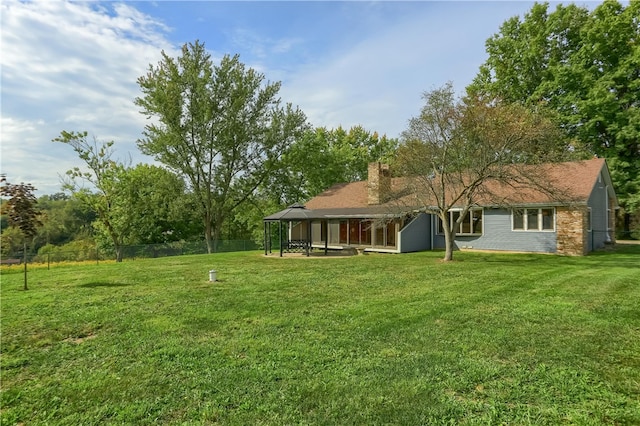 back of property featuring a lawn and a patio area