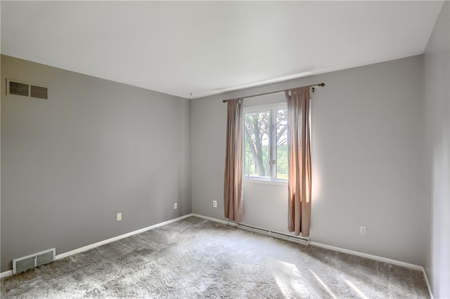 unfurnished room with carpet floors and baseboard heating