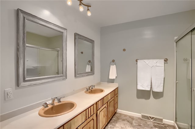 bathroom featuring vanity and a shower with shower door