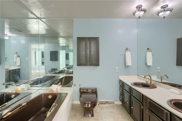 bathroom with a tub to relax in, tile patterned flooring, and sink