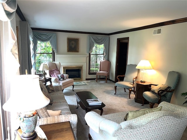 living room with ornamental molding, plenty of natural light, and carpet flooring