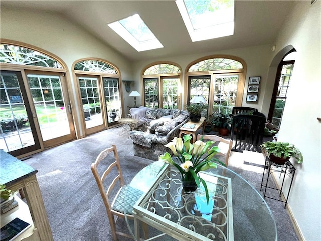 sunroom / solarium featuring lofted ceiling with skylight