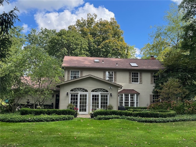 back of house with a lawn