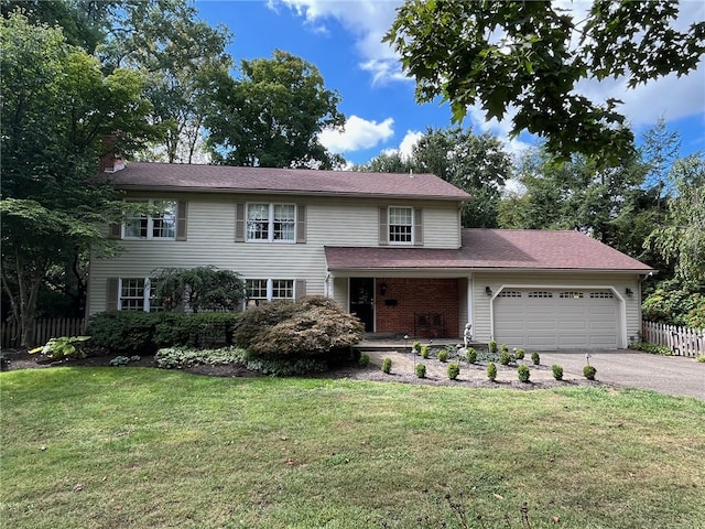 front facade with a garage and a front lawn