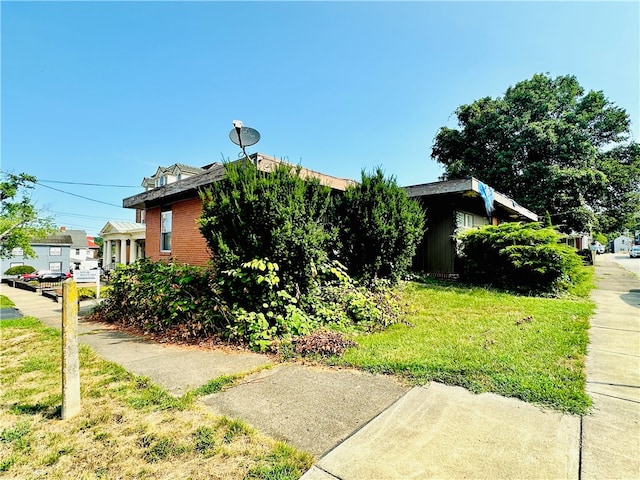 view of home's exterior with a yard