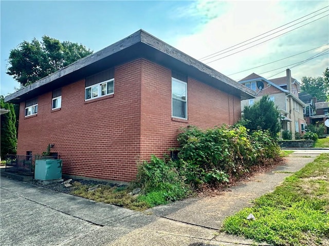 view of side of property featuring brick siding