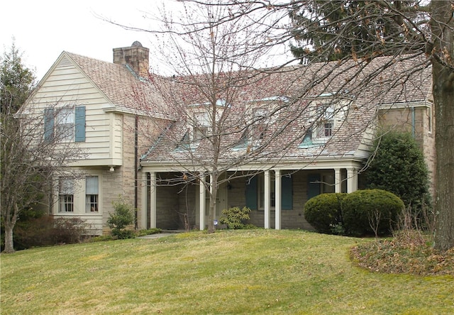 rear view of property featuring a yard