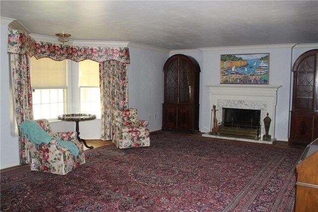 living room featuring hardwood / wood-style flooring, a fireplace, and crown molding