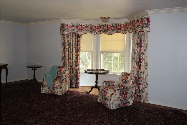 living area featuring hardwood / wood-style flooring and ornamental molding