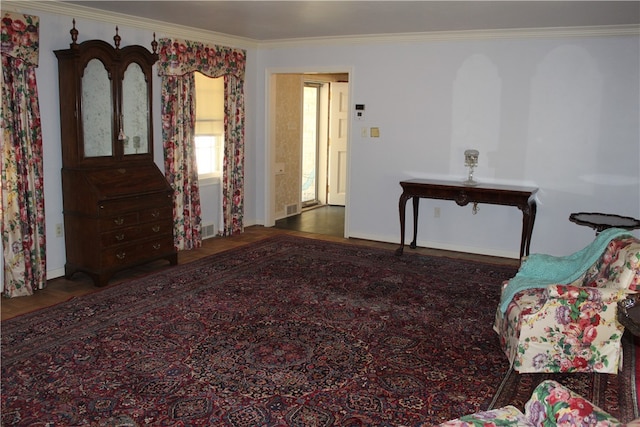 living area featuring ornamental molding and dark hardwood / wood-style flooring