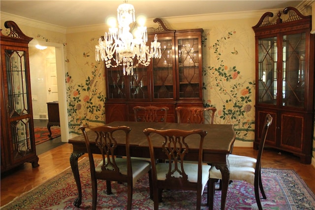 dining space featuring an inviting chandelier, hardwood / wood-style floors, and crown molding