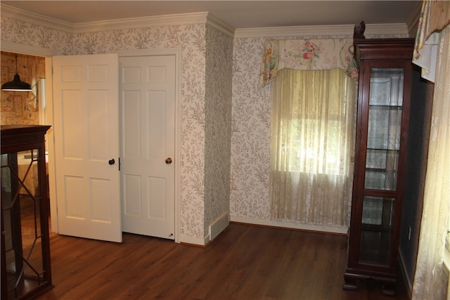 unfurnished bedroom featuring ornamental molding, dark hardwood / wood-style flooring, and a closet