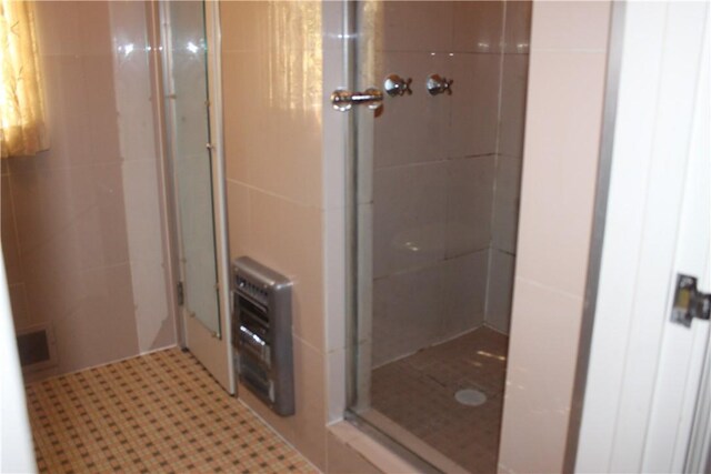 bathroom with walk in shower and heating unit