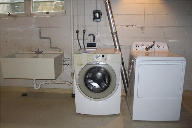 washroom featuring washer and clothes dryer and sink