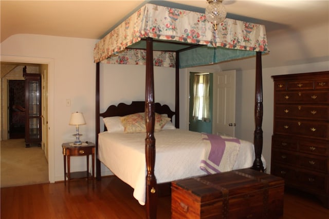 bedroom with dark hardwood / wood-style flooring