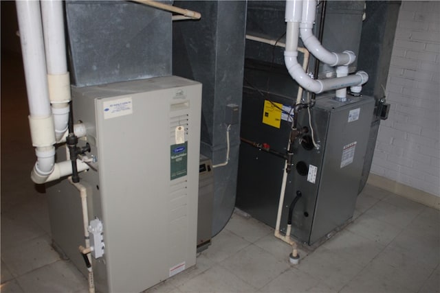 utility room featuring heating unit