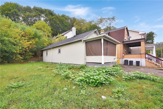 view of home's exterior with a lawn