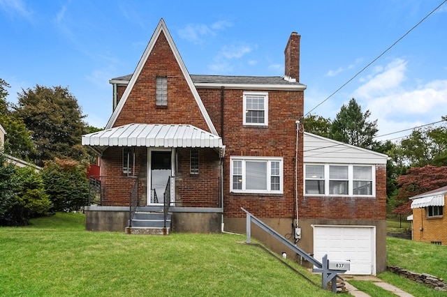 rear view of house featuring a garage and a lawn