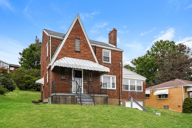 rear view of property with a lawn