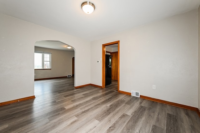 unfurnished room featuring wood-type flooring