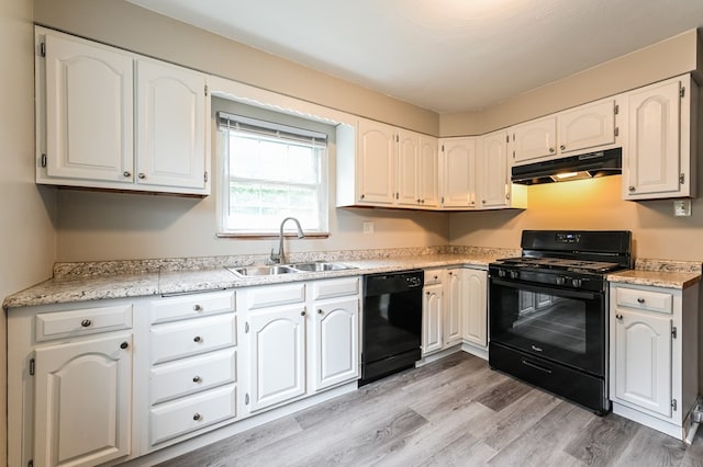 kitchen featuring sink, light hardwood / wood-style flooring, white cabinetry, and black appliances