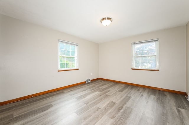 unfurnished room featuring light hardwood / wood-style floors