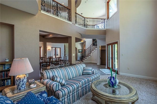 living room with a high ceiling and carpet flooring