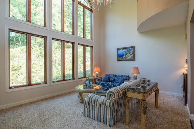 carpeted living room featuring a wealth of natural light and a towering ceiling