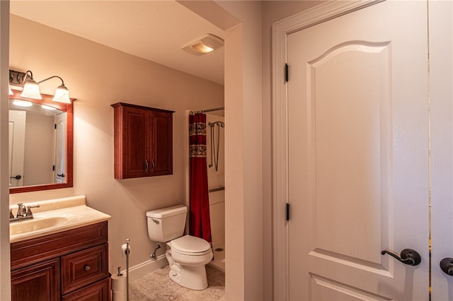 bathroom with tile patterned floors, curtained shower, vanity, and toilet