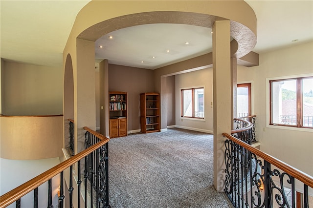 corridor with carpet flooring and plenty of natural light