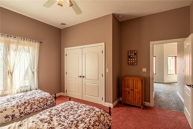 bedroom featuring ceiling fan, a closet, and carpet