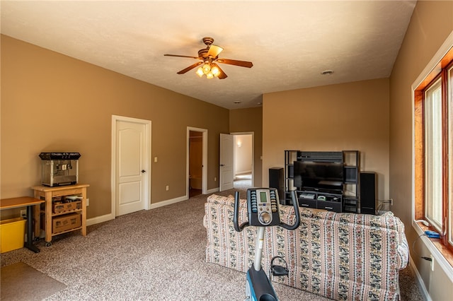 living room with ceiling fan, carpet floors, a textured ceiling, and a wealth of natural light