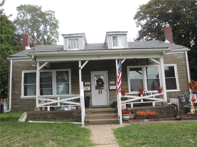 view of front of home with a front lawn and a porch