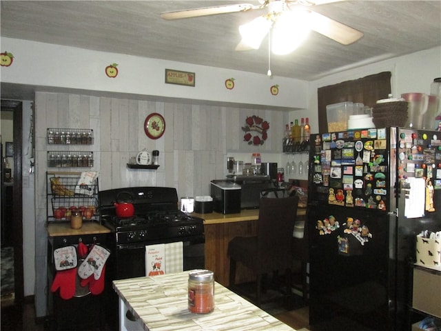 kitchen with a textured ceiling, black appliances, and ceiling fan