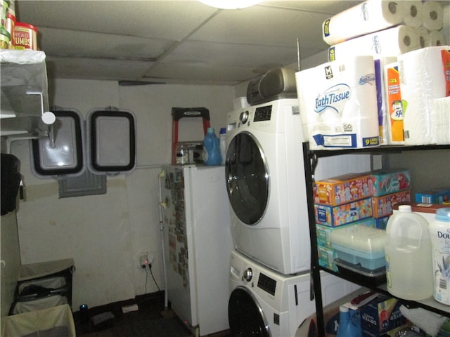 clothes washing area featuring stacked washer / drying machine