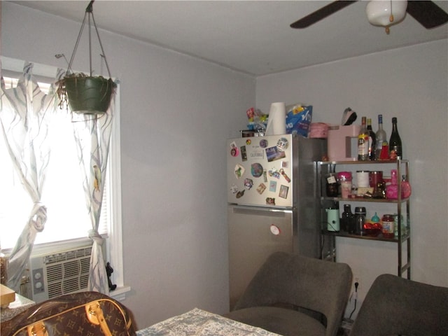 bedroom with cooling unit, ceiling fan, and stainless steel fridge